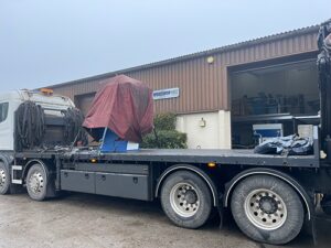 50 ton C frame press on the back of a lorry after being loaded with a high ab and secured for transport with cover to prevent from weather